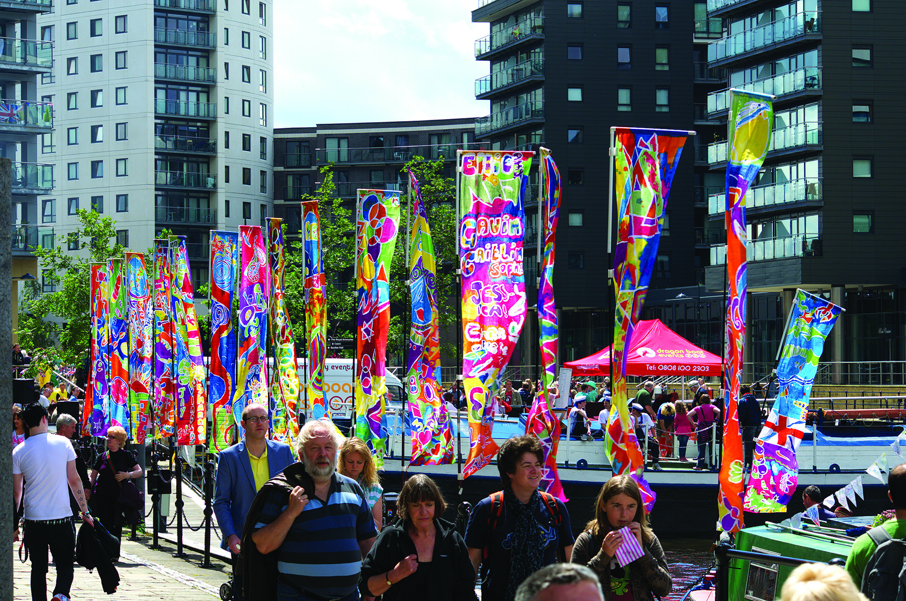 People of all ages walking around Leeds Dock during the summer months